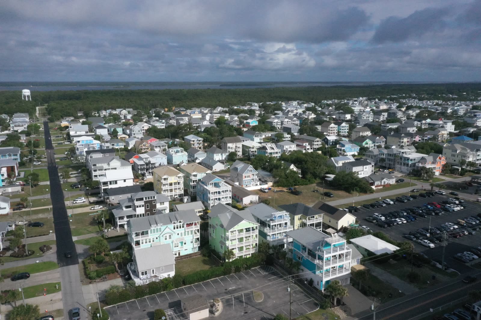 Aerial view of Carolina Beach with pastel houses between the river and the ocean