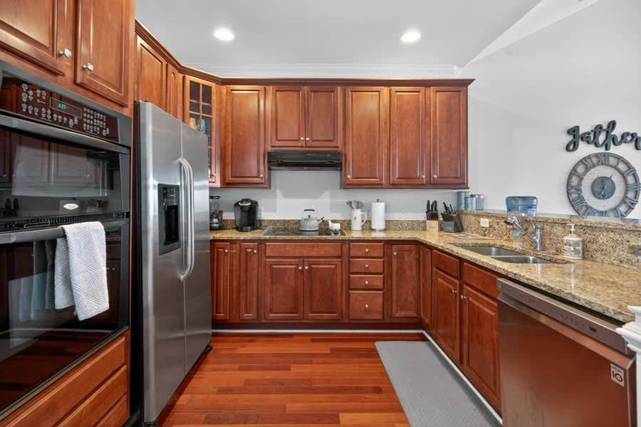Kitchen with granite counters, stainless appliances, and cherry cabinets